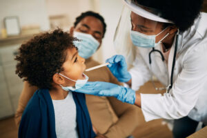 A child getting his teeth examined by a doctor