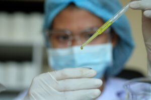Nurse analyzing a drop of moisture